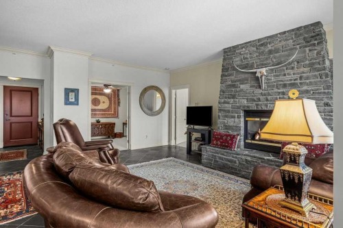 202-140 Stonecreek Road, Canmore, AB - Indoor Photo Showing Living Room With Fireplace