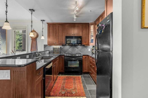 202-140 Stonecreek Road, Canmore, AB - Indoor Photo Showing Kitchen With Upgraded Kitchen