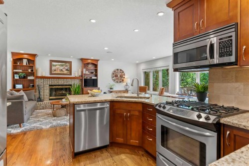 116 Sun Harbour Way Se, Calgary, AB - Indoor Photo Showing Kitchen With Fireplace With Upgraded Kitchen
