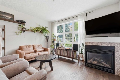 305-532 5 Avenue Ne, Calgary, AB - Indoor Photo Showing Living Room With Fireplace
