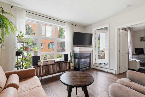 305-532 5 Avenue Ne, Calgary, AB - Indoor Photo Showing Living Room With Fireplace