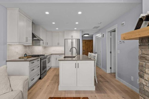 409-1105 Spring Creek Drive, Canmore, AB - Indoor Photo Showing Kitchen With Stainless Steel Kitchen With Upgraded Kitchen