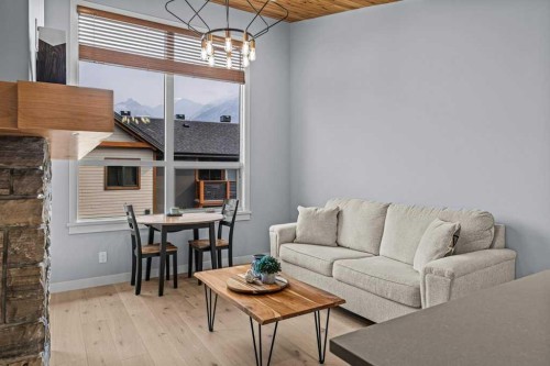 409-1105 Spring Creek Drive, Canmore, AB - Indoor Photo Showing Living Room
