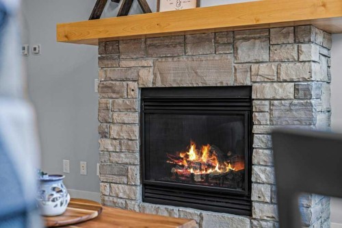 409-1105 Spring Creek Drive, Canmore, AB - Indoor Photo Showing Living Room With Fireplace