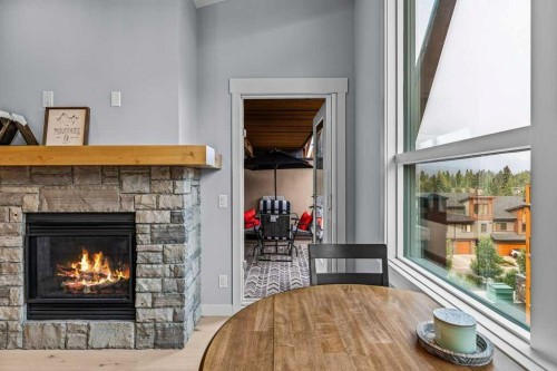 409-1105 Spring Creek Drive, Canmore, AB - Indoor Photo Showing Living Room With Fireplace
