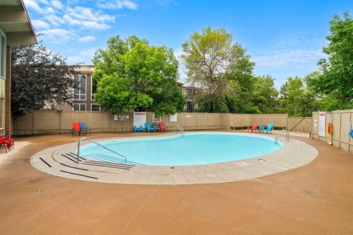 607-8948 Elbow Drive Sw, Calgary, AB - Outdoor With In Ground Pool With Backyard