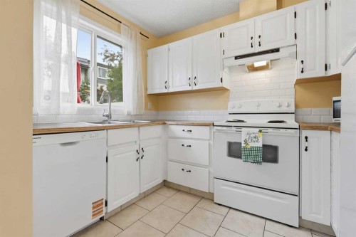 224-999 Canyon Meadows Drive Sw, Calgary, AB - Indoor Photo Showing Kitchen With Double Sink