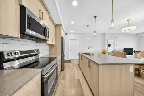 1211-220 Seton Grove Se, Calgary, AB - Indoor Photo Showing Kitchen With Stainless Steel Kitchen With Upgraded Kitchen