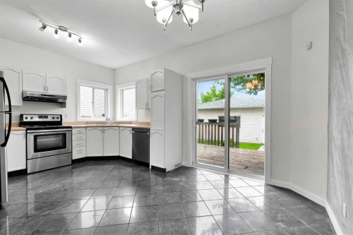7097 Laguna Way Ne, Calgary, AB - Indoor Photo Showing Kitchen With Stainless Steel Kitchen With Double Sink