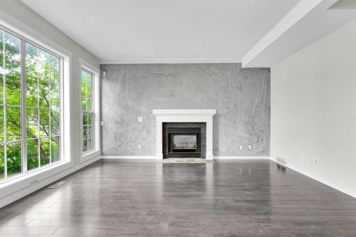 7097 Laguna Way Ne, Calgary, AB - Indoor Photo Showing Living Room With Fireplace