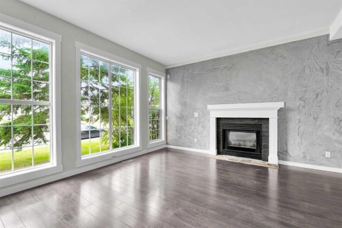 7097 Laguna Way Ne, Calgary, AB - Indoor Photo Showing Living Room With Fireplace
