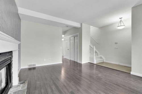 7097 Laguna Way Ne, Calgary, AB - Indoor Photo Showing Other Room With Fireplace