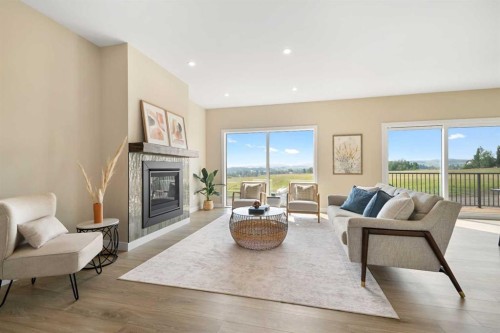 329 Flare Avenue Sw, Diamond Valley, AB - Indoor Photo Showing Living Room With Fireplace