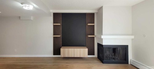 29-2400 15 Street Sw, Calgary, AB - Indoor Photo Showing Other Room With Fireplace