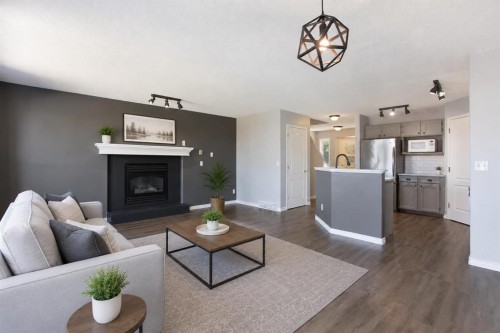 7269 Laguna Way Ne, Calgary, AB - Indoor Photo Showing Living Room With Fireplace