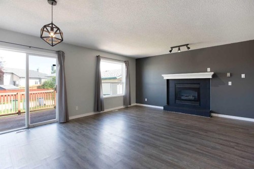7269 Laguna Way Ne, Calgary, AB - Indoor Photo Showing Living Room With Fireplace