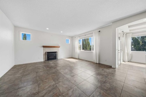 204 Eversyde Mews Sw, Calgary, AB - Indoor Photo Showing Other Room With Fireplace
