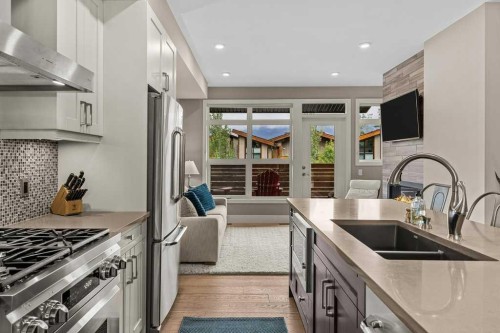 418 Riva Heights, Canmore, AB - Indoor Photo Showing Kitchen With Stainless Steel Kitchen With Double Sink With Upgraded Kitchen