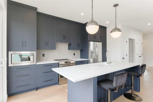 96 Fireside Common, Cochrane, AB - Indoor Photo Showing Kitchen With Stainless Steel Kitchen With Upgraded Kitchen