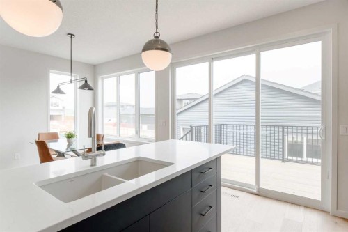 96 Fireside Common, Cochrane, AB - Indoor Photo Showing Kitchen With Double Sink