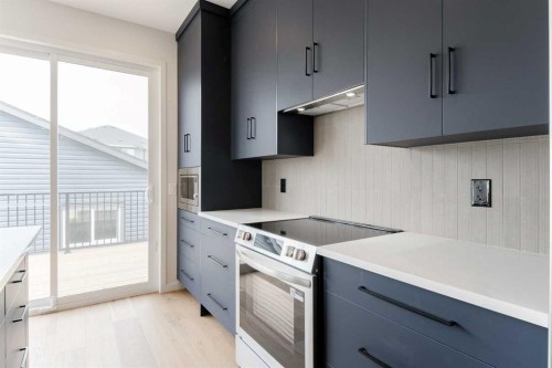 96 Fireside Common, Cochrane, AB - Indoor Photo Showing Kitchen