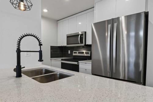 214 Seton Passage Se, Calgary, AB - Indoor Photo Showing Kitchen With Stainless Steel Kitchen With Double Sink With Upgraded Kitchen