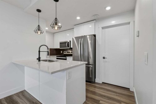 214 Seton Passage Se, Calgary, AB - Indoor Photo Showing Kitchen With Stainless Steel Kitchen With Double Sink With Upgraded Kitchen