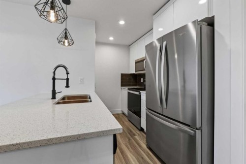 214 Seton Passage Se, Calgary, AB - Indoor Photo Showing Kitchen With Stainless Steel Kitchen With Double Sink