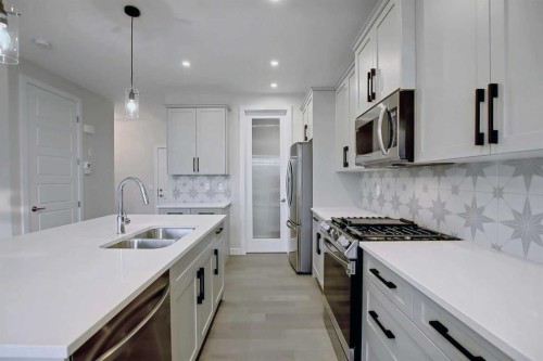 12 Topaz Place, Cochrane, AB - Indoor Photo Showing Kitchen With Double Sink With Upgraded Kitchen