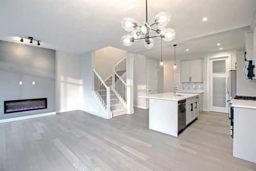 12 Topaz Place, Cochrane, AB - Indoor Photo Showing Kitchen With Fireplace