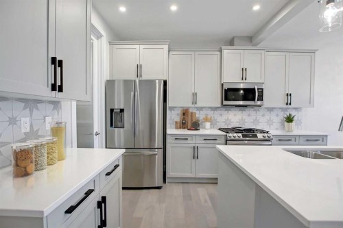 12 Topaz Place, Cochrane, AB - Indoor Photo Showing Kitchen With Double Sink With Upgraded Kitchen