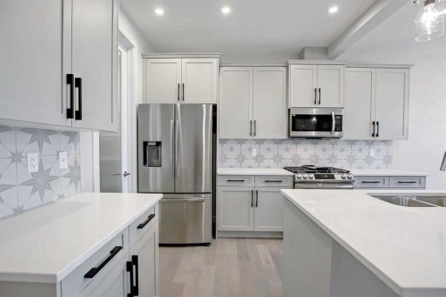 12 Topaz Place, Cochrane, AB - Indoor Photo Showing Kitchen With Double Sink With Upgraded Kitchen