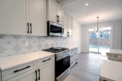 12 Topaz Place, Cochrane, AB - Indoor Photo Showing Kitchen With Double Sink With Upgraded Kitchen