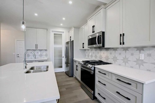 12 Topaz Place, Cochrane, AB - Indoor Photo Showing Kitchen With Double Sink With Upgraded Kitchen
