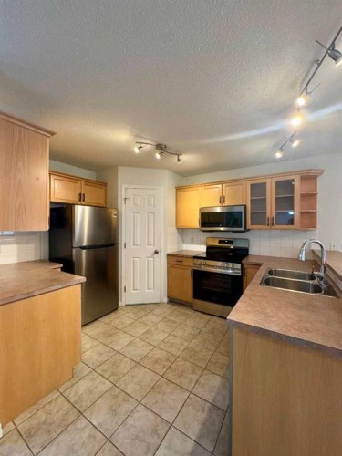 66 Chaparral Ridge Terrace Se, Calgary, AB - Indoor Photo Showing Kitchen With Double Sink