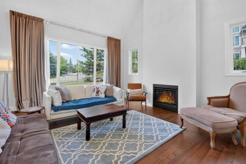 8 Spring Valley Lane Sw, Calgary, AB - Indoor Photo Showing Living Room With Fireplace