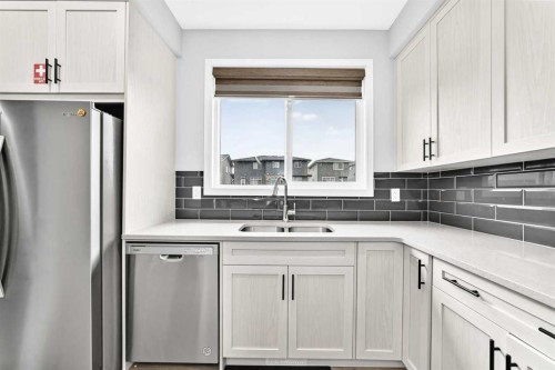 164 Langwell Common Se, Airdrie, AB - Indoor Photo Showing Kitchen With Stainless Steel Kitchen With Double Sink