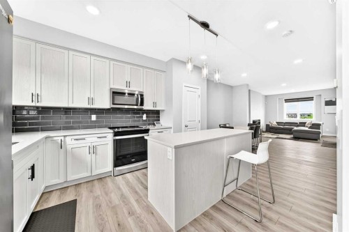 164 Langwell Common Se, Airdrie, AB - Indoor Photo Showing Kitchen With Upgraded Kitchen