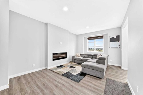 164 Langwell Common Se, Airdrie, AB - Indoor Photo Showing Living Room With Fireplace