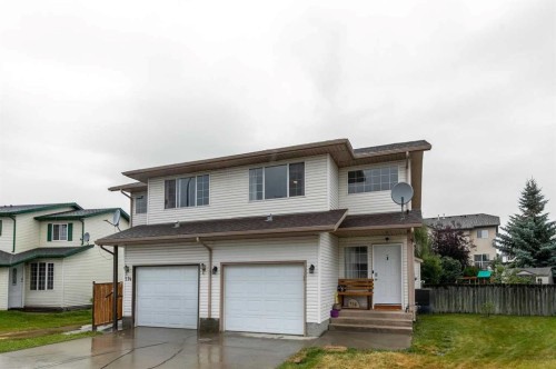 116 Quigley Close, Cochrane, AB - Outdoor With Facade