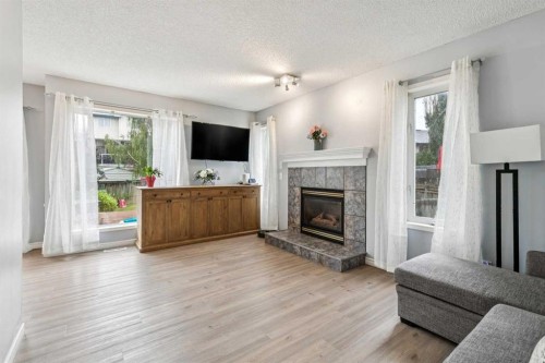 116 Quigley Close, Cochrane, AB - Indoor Photo Showing Living Room With Fireplace