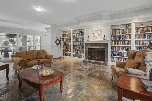 205-15 Everstone Drive Sw, Calgary, AB - Indoor Photo Showing Living Room With Fireplace