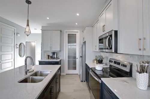 16 Topaz Place, Cochrane, AB - Indoor Photo Showing Kitchen With Double Sink With Upgraded Kitchen