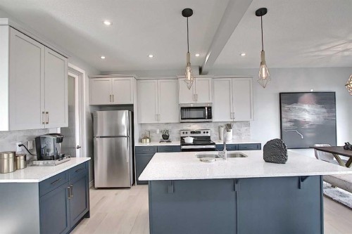 16 Topaz Place, Cochrane, AB - Indoor Photo Showing Kitchen With Double Sink With Upgraded Kitchen