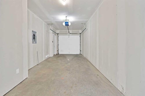 209-101 Panatella Square Nw, Calgary, AB - Indoor Photo Showing Garage