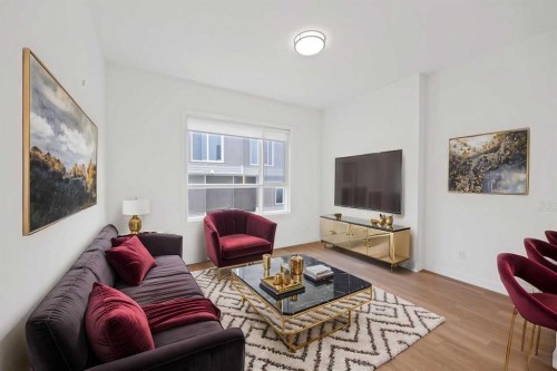 209-101 Panatella Square Nw, Calgary, AB - Indoor Photo Showing Living Room