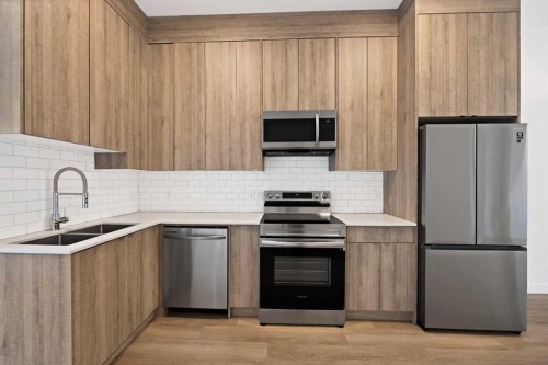 209-101 Panatella Square Nw, Calgary, AB - Indoor Photo Showing Kitchen With Double Sink With Upgraded Kitchen