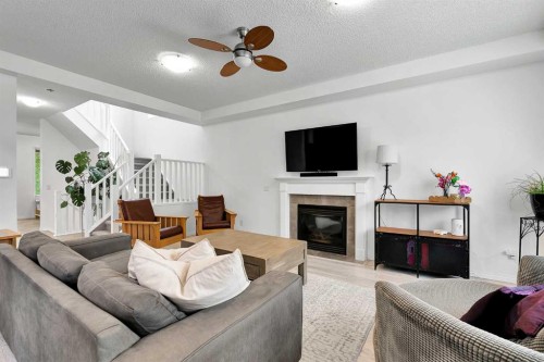 122 Windridge Road Sw, Airdrie, AB - Indoor Photo Showing Living Room With Fireplace