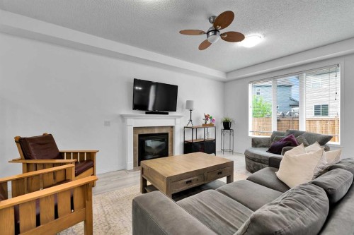 122 Windridge Road Sw, Airdrie, AB - Indoor Photo Showing Living Room With Fireplace
