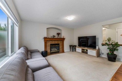10 Evansmeade Manor Nw, Calgary, AB - Indoor Photo Showing Living Room With Fireplace